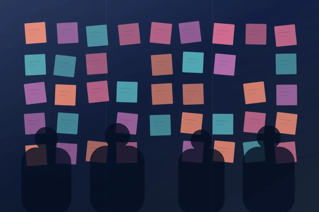 Four colleagues silhouetted at a glass wall covered in coral, orchid and teal sticky notes